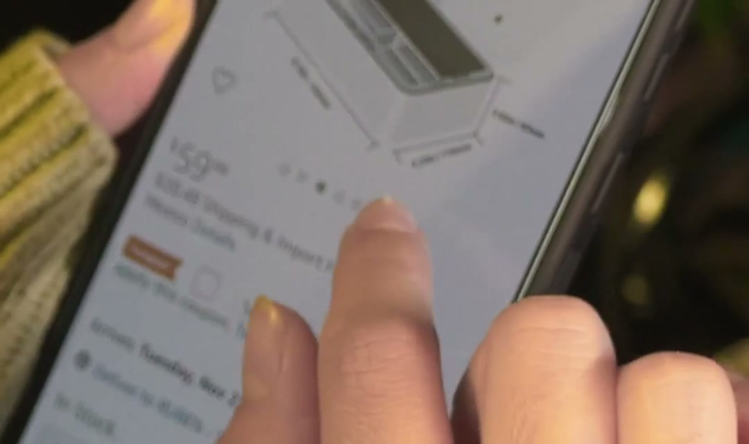 Woman exploring an online sales page on her cell phone