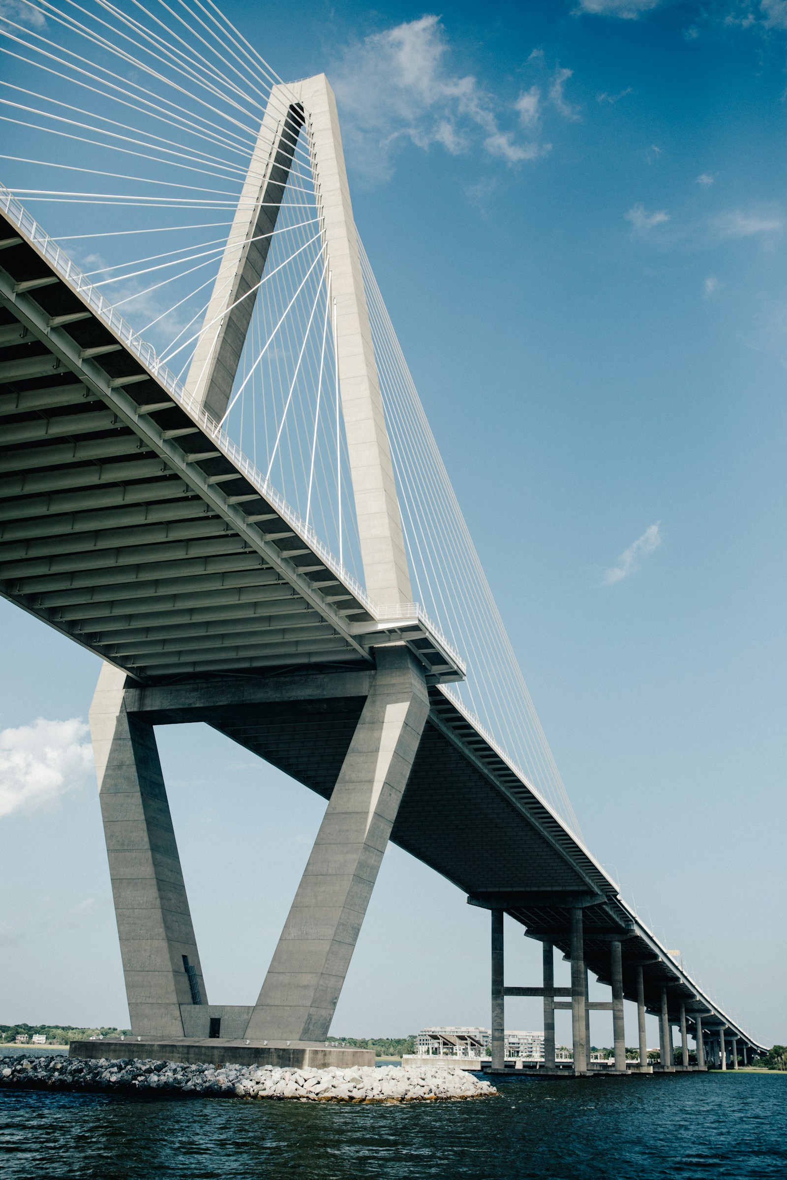 The structure and cables of a bridge stretching across water.