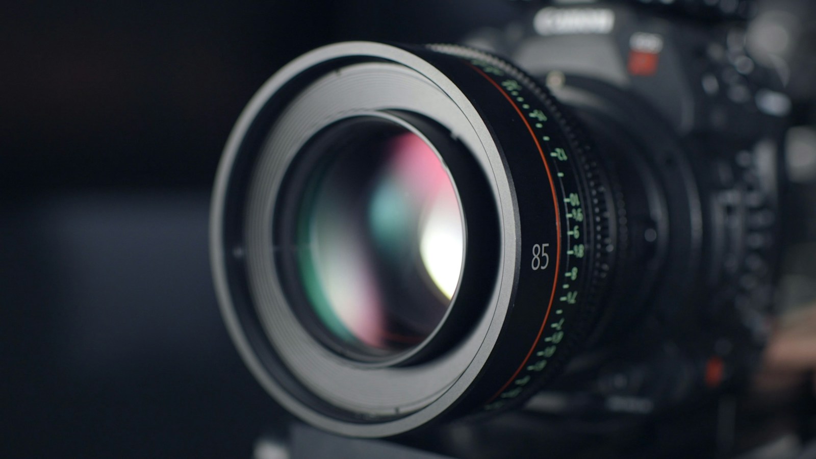 Close-up of a camera lens with reflected light in its glass.