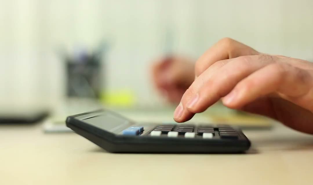 Person doing calculations with a calculator