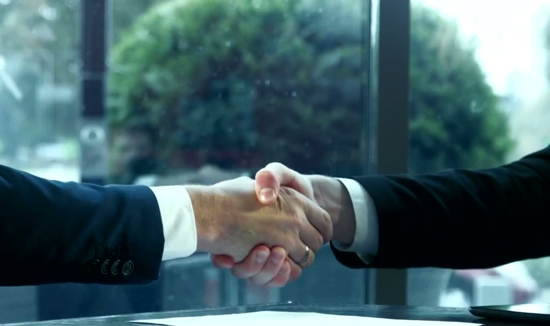 Shaking hands and signing contract