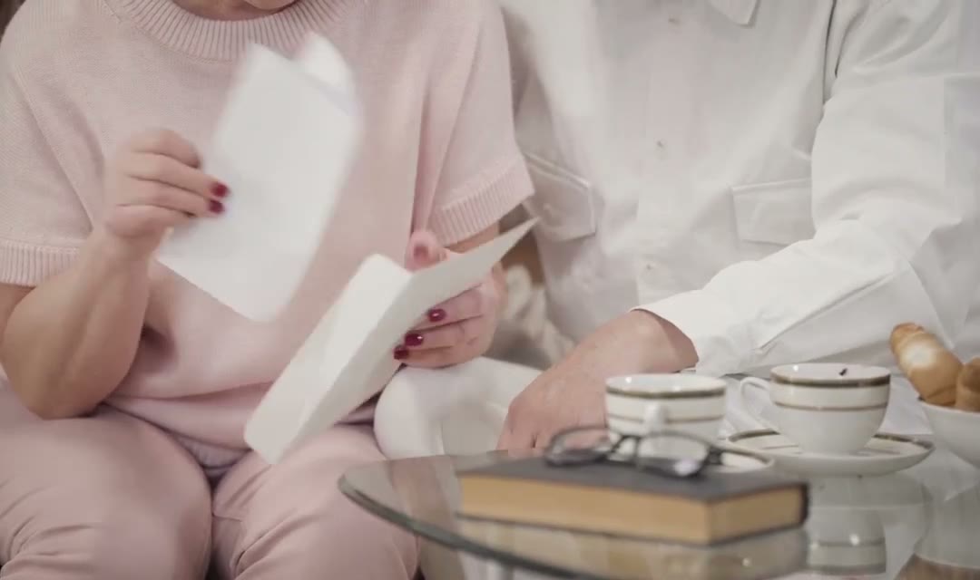 Grandparents reading a letter from their family