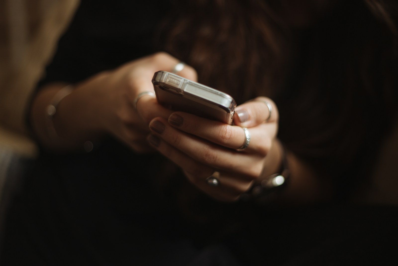 Close-up of a person holding and using a smartphone.