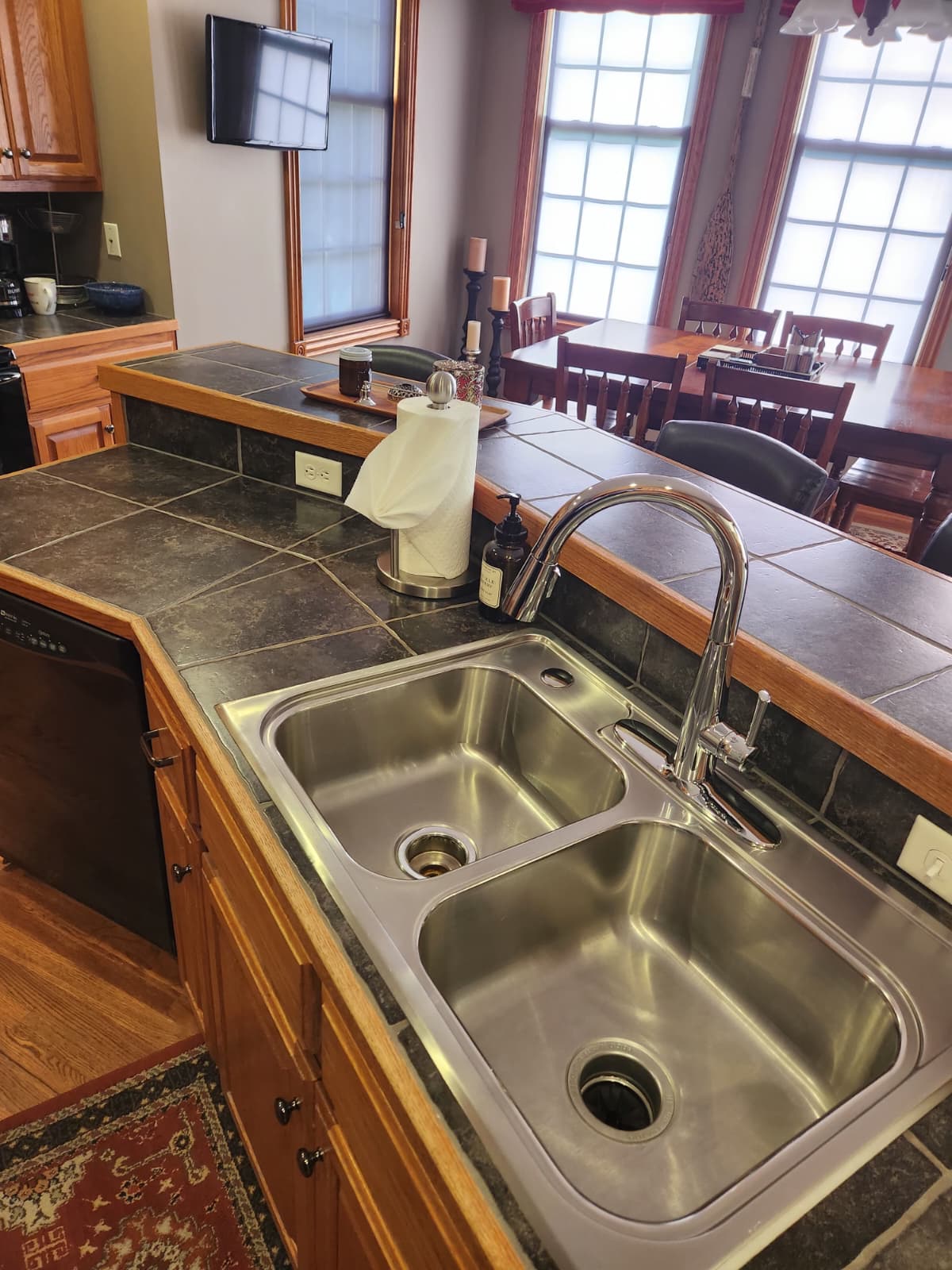 Clean double sink and chrome faucet with tiled counters in the Lincoln kitchen