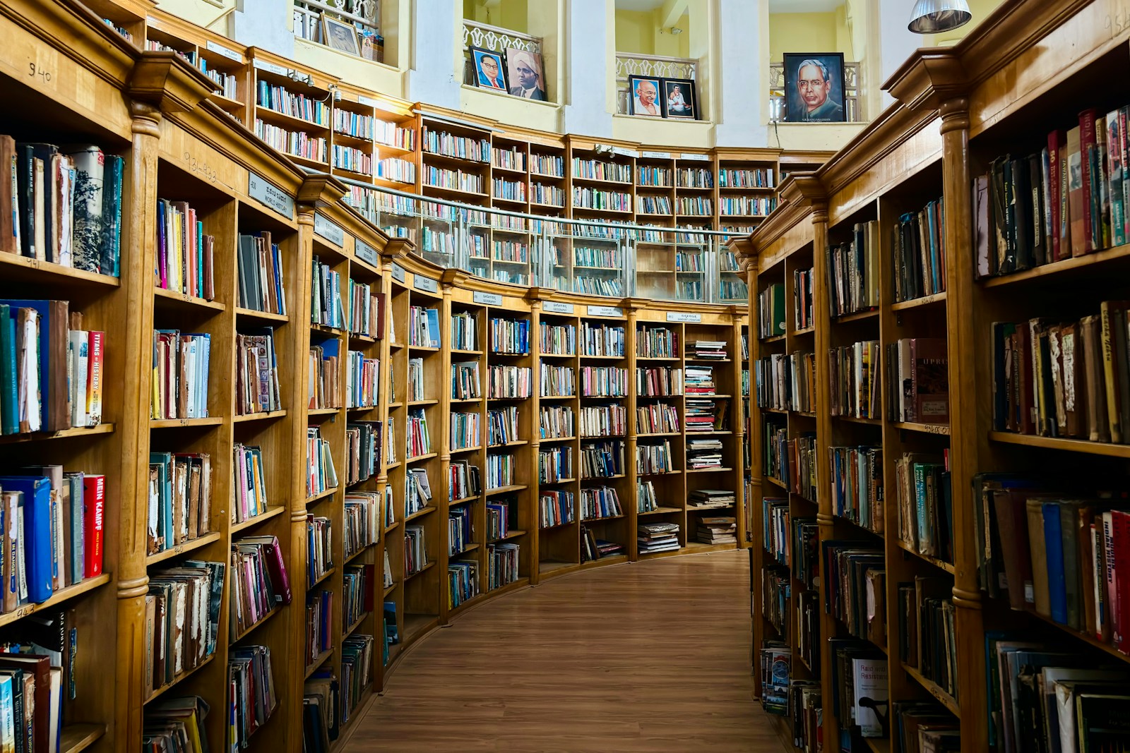 Tall library shelves filled with books in a quiet reading space.