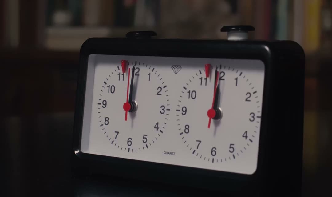 Close up shot of a chess clock featuring two analog dials used to keep track of each player's time during a chess game